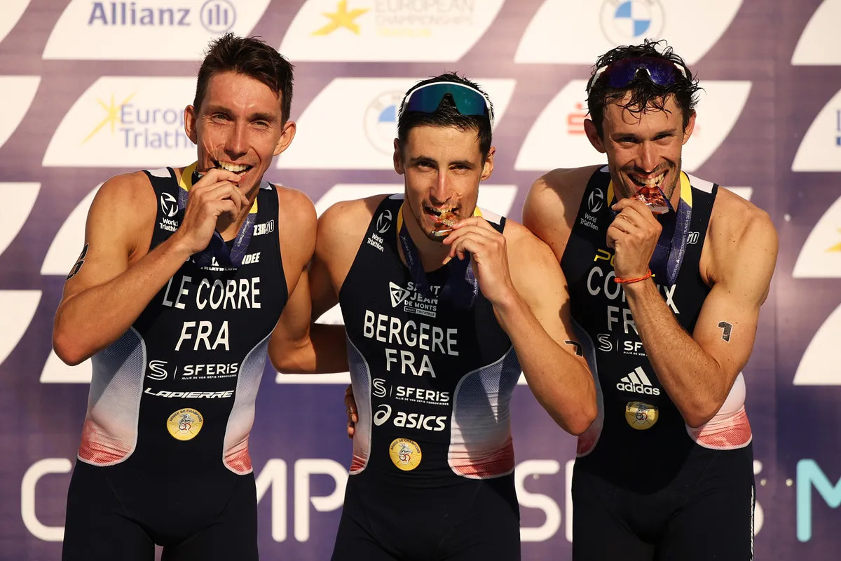 MUNICH, GERMANY - AUGUST 13: Gold medalist, Leo Bergere of France, silver medalist Pierre le Corre of France and bronze medalist Dorian Coninx of France celebrate on the podium after competing in the Elite Men's Triathlon competition on day 3 of the European Championships Munich 2022 at Olympiapark on August 13, 2022 in Munich, Germany. (Photo by Adam Pretty/Getty Images)