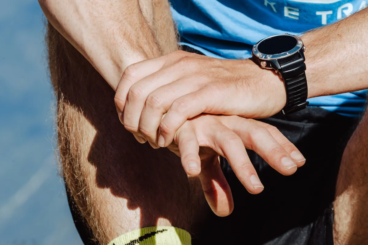 Holding hand with triathlon watch