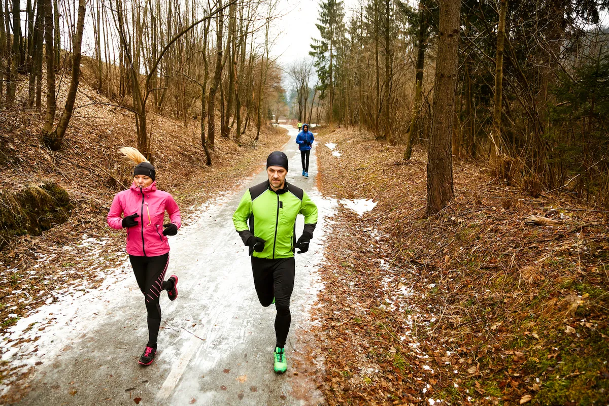 A group of people running in winter wearing warm run clothing