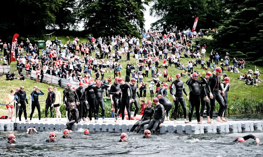Athletes warm up in the water ahead of the Blenheim Palace Triathlon
