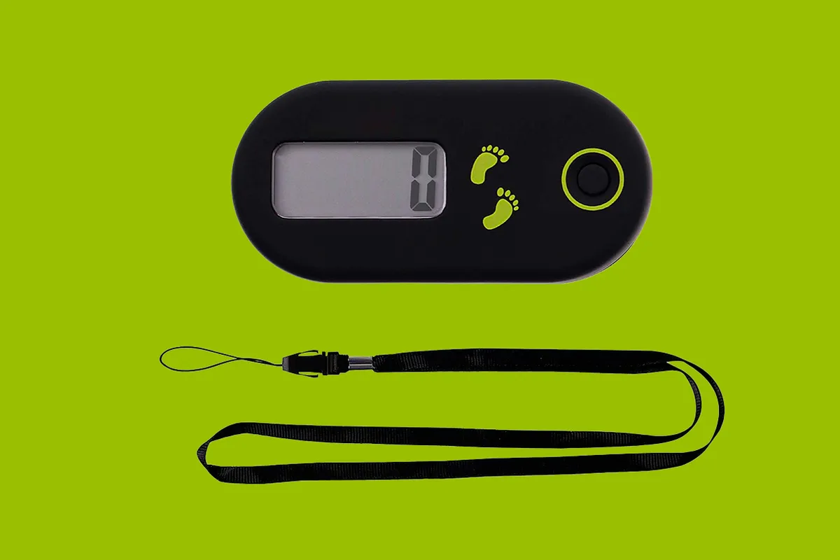 WINOMO Portable Walking Digital Pedometer on a green background
