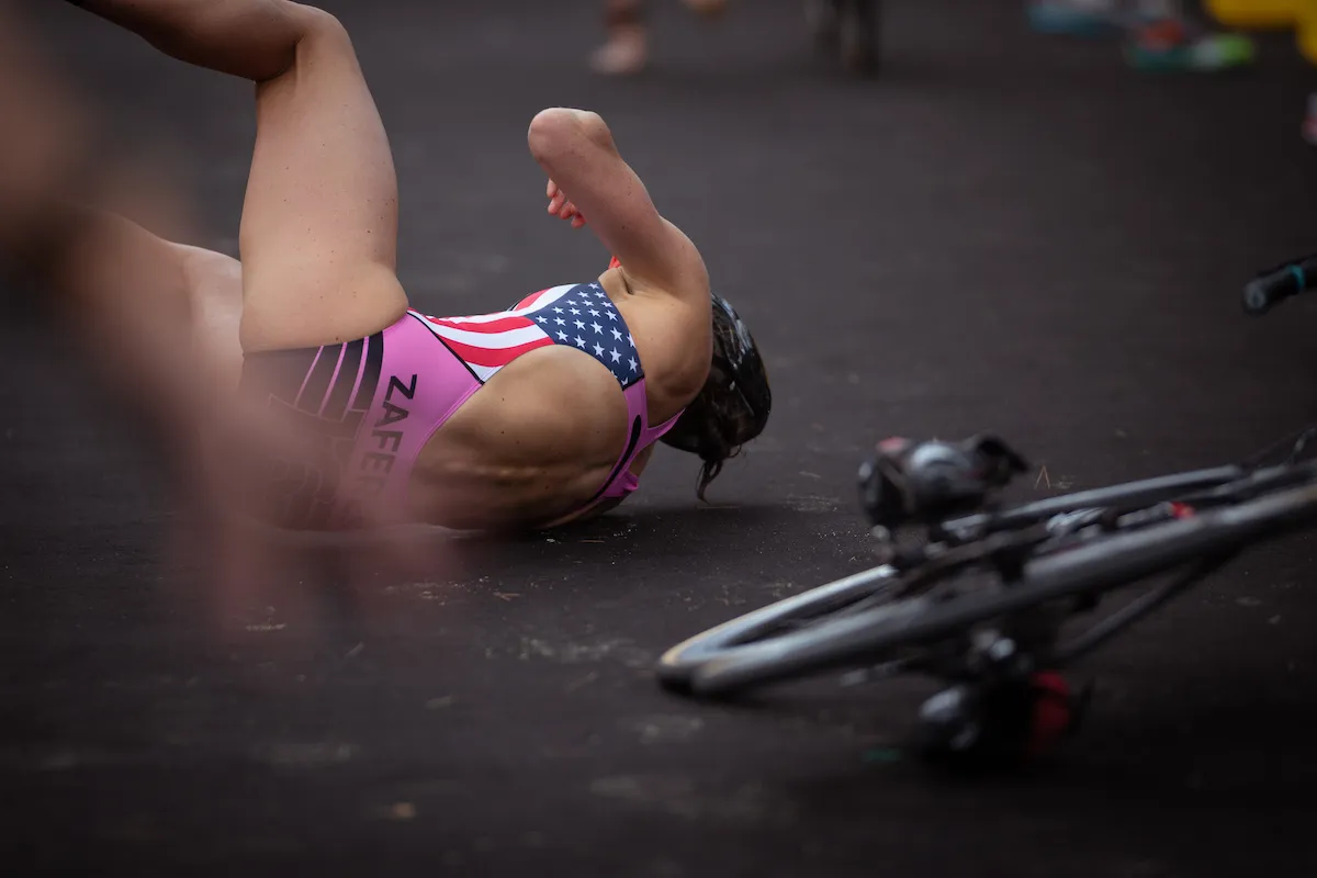 The USA'S Katie Zaferes lies on the floor on her side after crashing during the Sprint Enduro Stage Two race at the 2018 Mallorca Super League Triathlon.