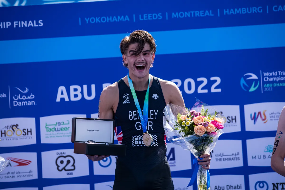 Connor Bentley looking surprised but very happy on the top step of the podium at the 2022 U23 World Champs, Abu Dhabi