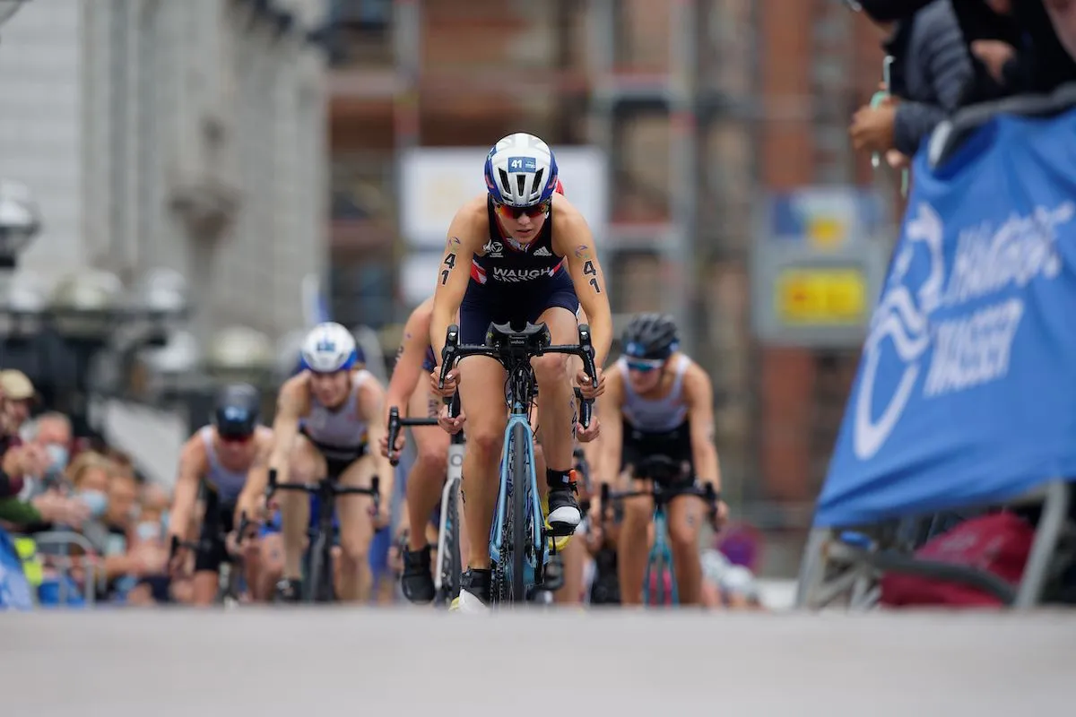 GB triathlete Kate Waugh on the bike at the head of a group of cyclists at the 2021 Hamburg World Triathlon Championship Series race