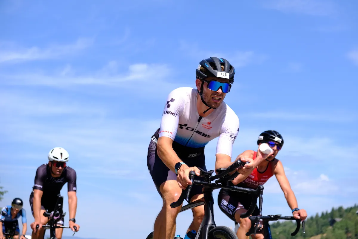 Male cyclists racing in the heat at the 2022 Alpe d'Huez Triathlon