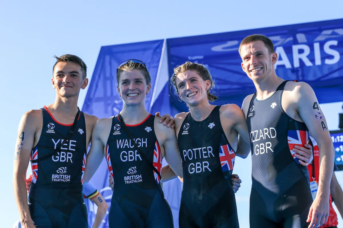 L-R: Alex Yee, Kate Waugh, Beth Potter and Barclay Izzard arm in arm, smiling for the camera having won silver in the Paris Olympics Mixed Team Relay Test Event
