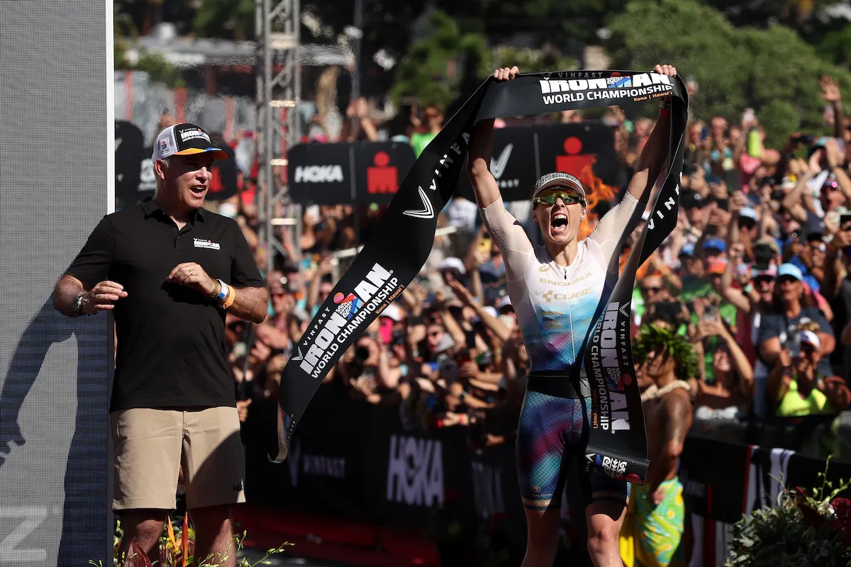 GB pro triathlete Lucy Charles-Barclay crosses the line, arms aloft, to win the 2023 Ironman World Championship