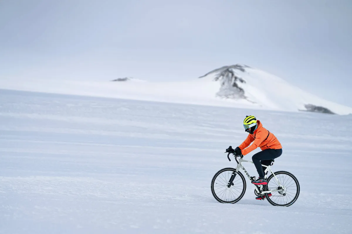 Raymond cycling across ice in Novo, Antarctica, as part of his epic, global triathlon challenge