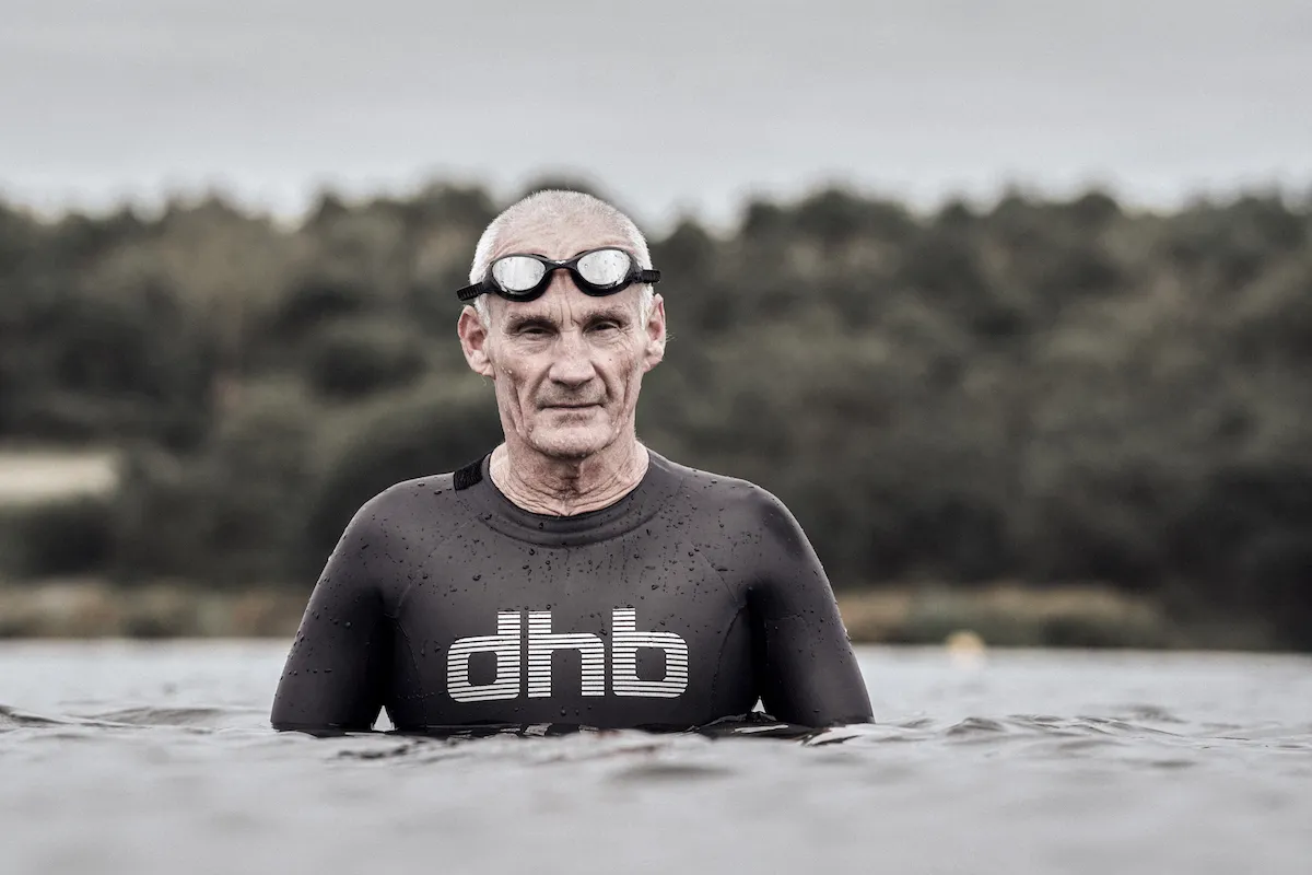 Mike Harris in a wetsuit appearing out of the water 