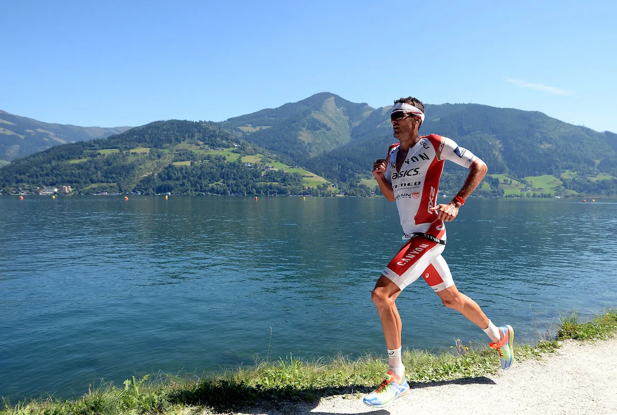 Jan Frodeno running alongside the lake route to winning the 2015 Ironman 70.3 Worlds, in Zell am 
See-Kaprun, Austria.  