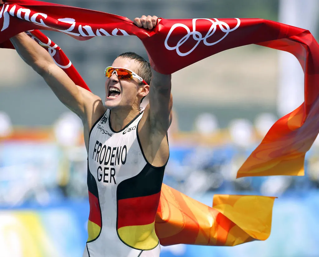 Germany's Jan Frodeno celebrates as he crosses the finish line of the men's triathlon competition at the Beijing 2008 Olympic Games on August 19, 2008.  
