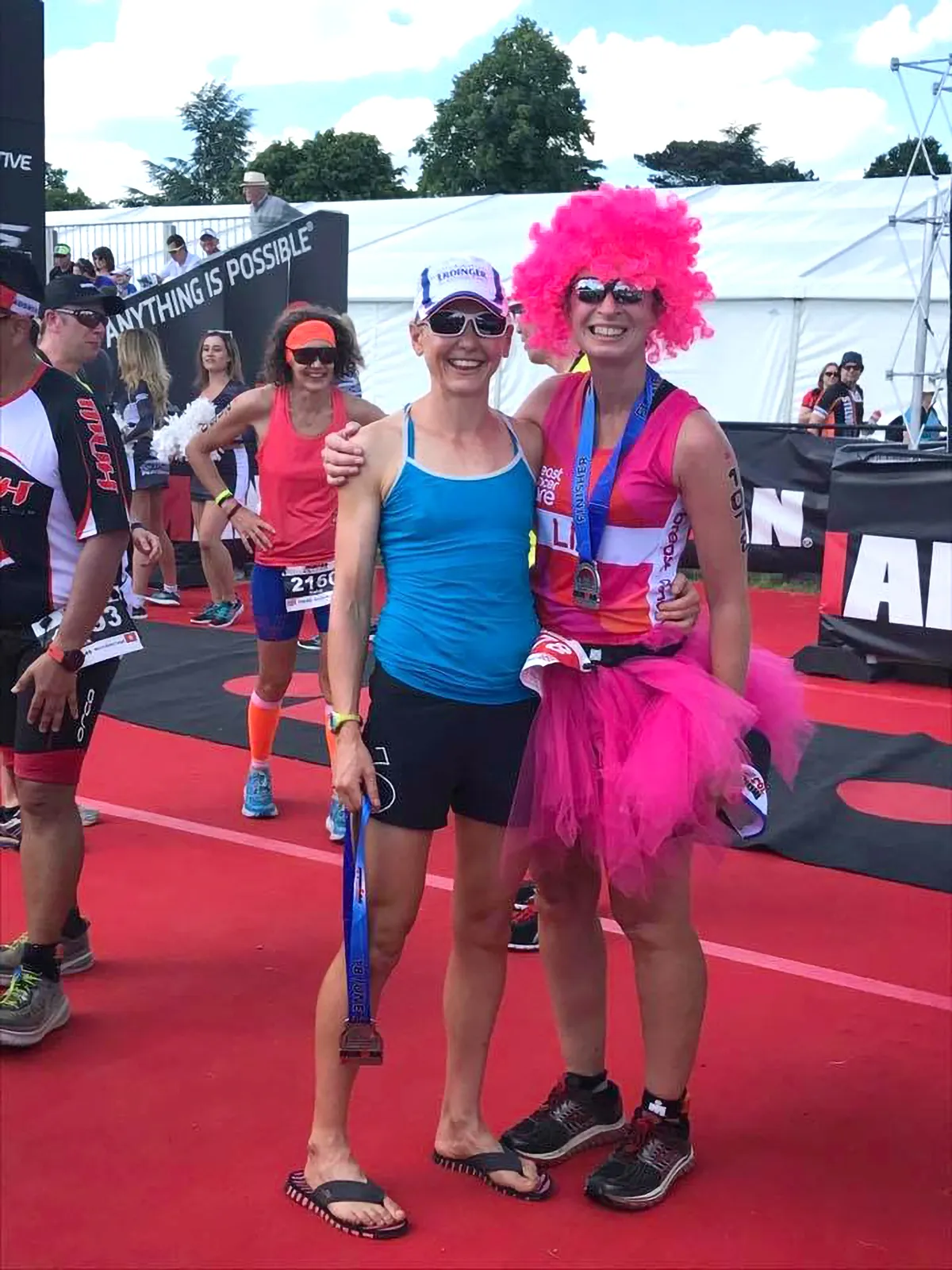 Cancer doctor and former pro Lucy Gossage, left, presents Dr Liz O'Riordan with her medal at Ironman 70.3 Staffs in 2017