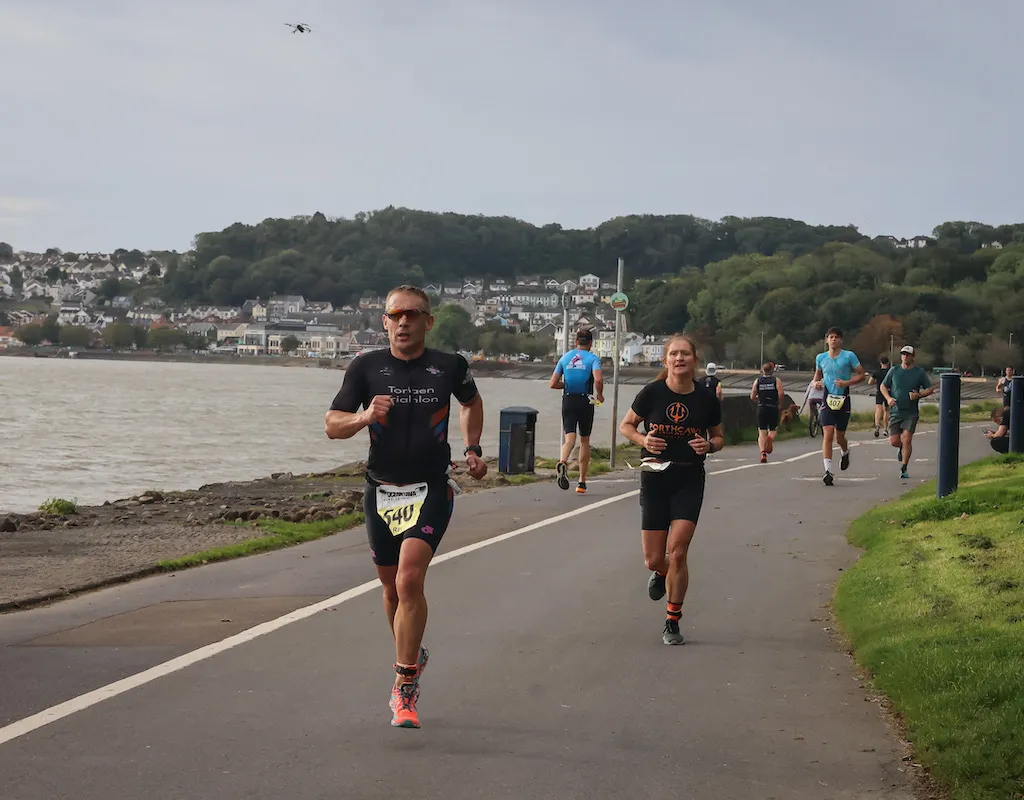 Image of runners running towards the camera at the 2023 Mumbles Triathlon 