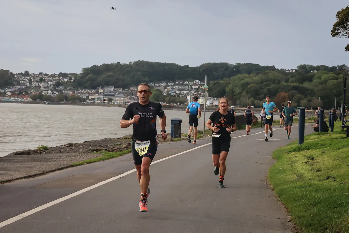 Image of runners running towards the camera at the 2023 Mumbles Triathlon 