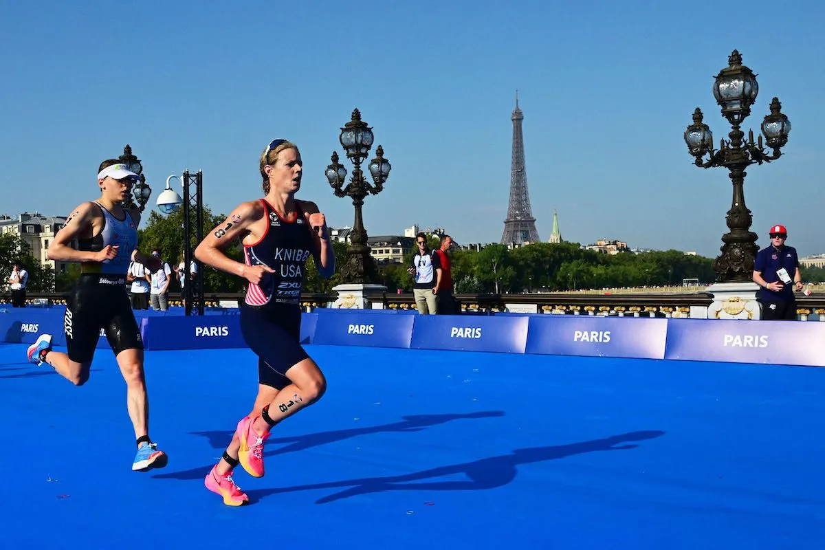 US triathlete Taylor Knibb (R) and Germany's Laura Lindemann running on the Alexandre III bridge at the 2023 Paris Olympics triathlon test event
