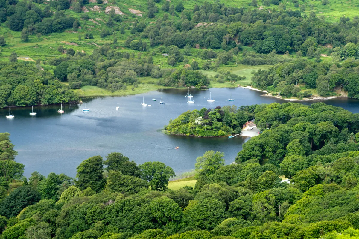 Lake with boats surrounded by countryside