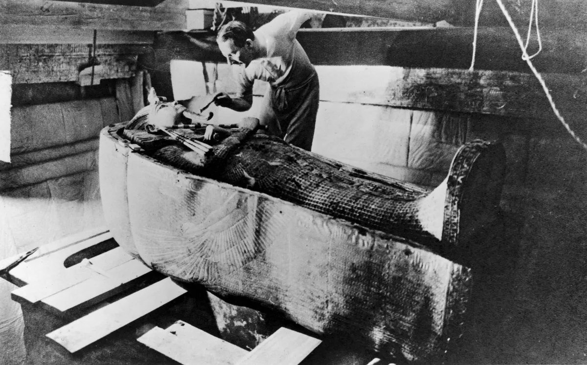Archaeologist Howard Carter opening the coffin of Tutankhamun, 1922