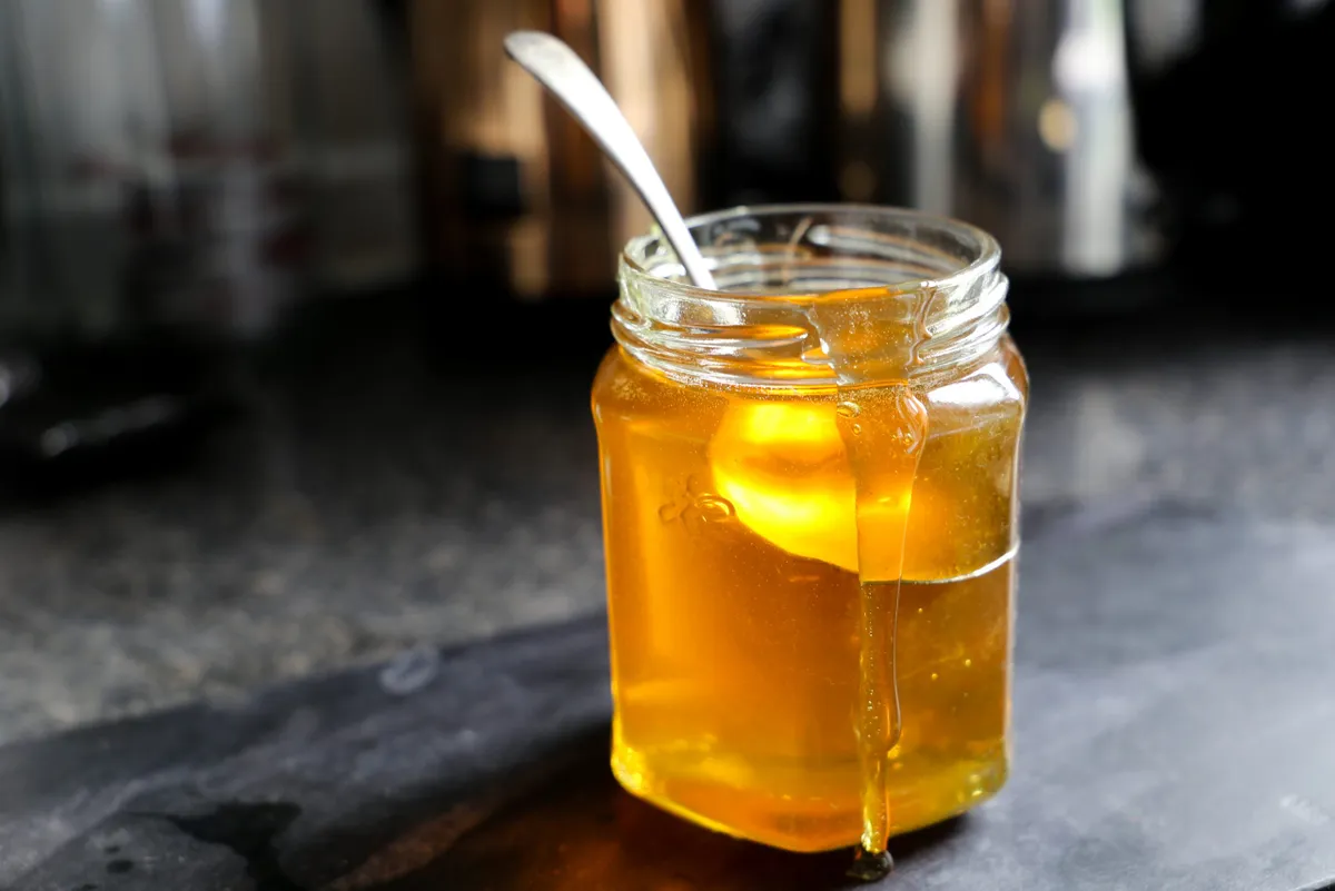 Jar of honey with spoon in it