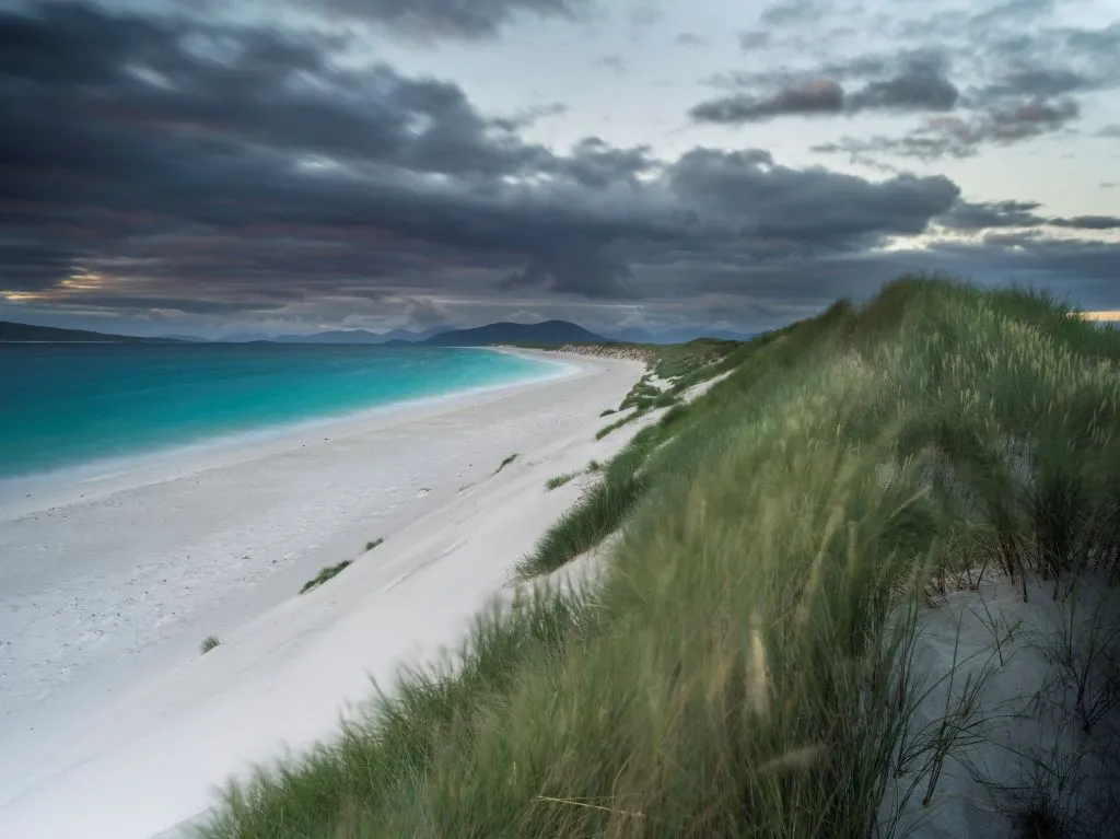 Isle of Berneray (Bearnaraidh). a small island located in the sound of Harris at the nothern tip of North Uist. West Beach with the mountains of Harris in the background. Europe. Scotland. June. (Photo by: Martin Zwick/REDA&CO/UIG via Getty Images)