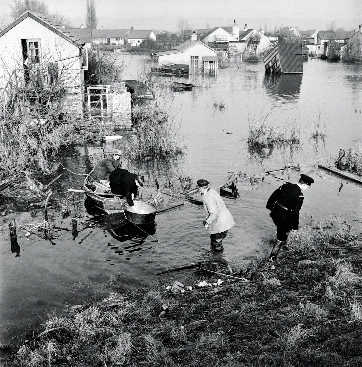 21st February 1953: Residents trying to salvage possessions from houses surrounded by floodwater on Canvey Island. Original Publication: Picture Post - 6423 - Floods - Return To Canvey Island: One Man's Story - pub. 1953 (Photo by Raymond Kleboe/Picture Post/Getty Images)