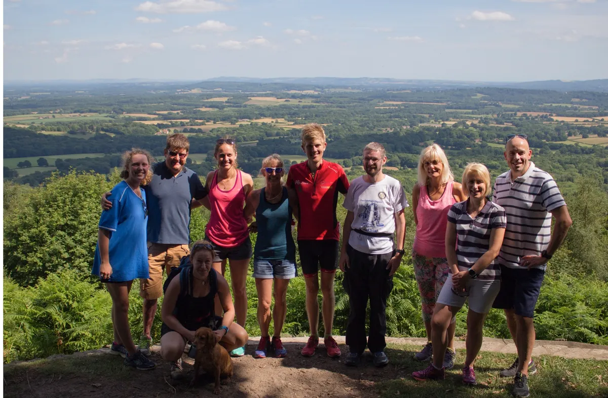 Group of adult hikers at top of hillside