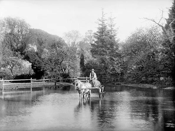 EWELME, Oxfordshire. A young man with a horse and cart, laden with a barrel, crossing the village pond. Probably the water carrier. (Photo by Henry Taunt/English Heritage/Arcaid/Corbis via Getty Images)