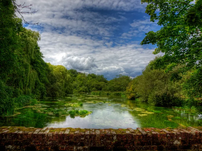 This is the River Itchen as it flows under an ancient brick at Itchen Stoke, near Winchester in Hampshire.
