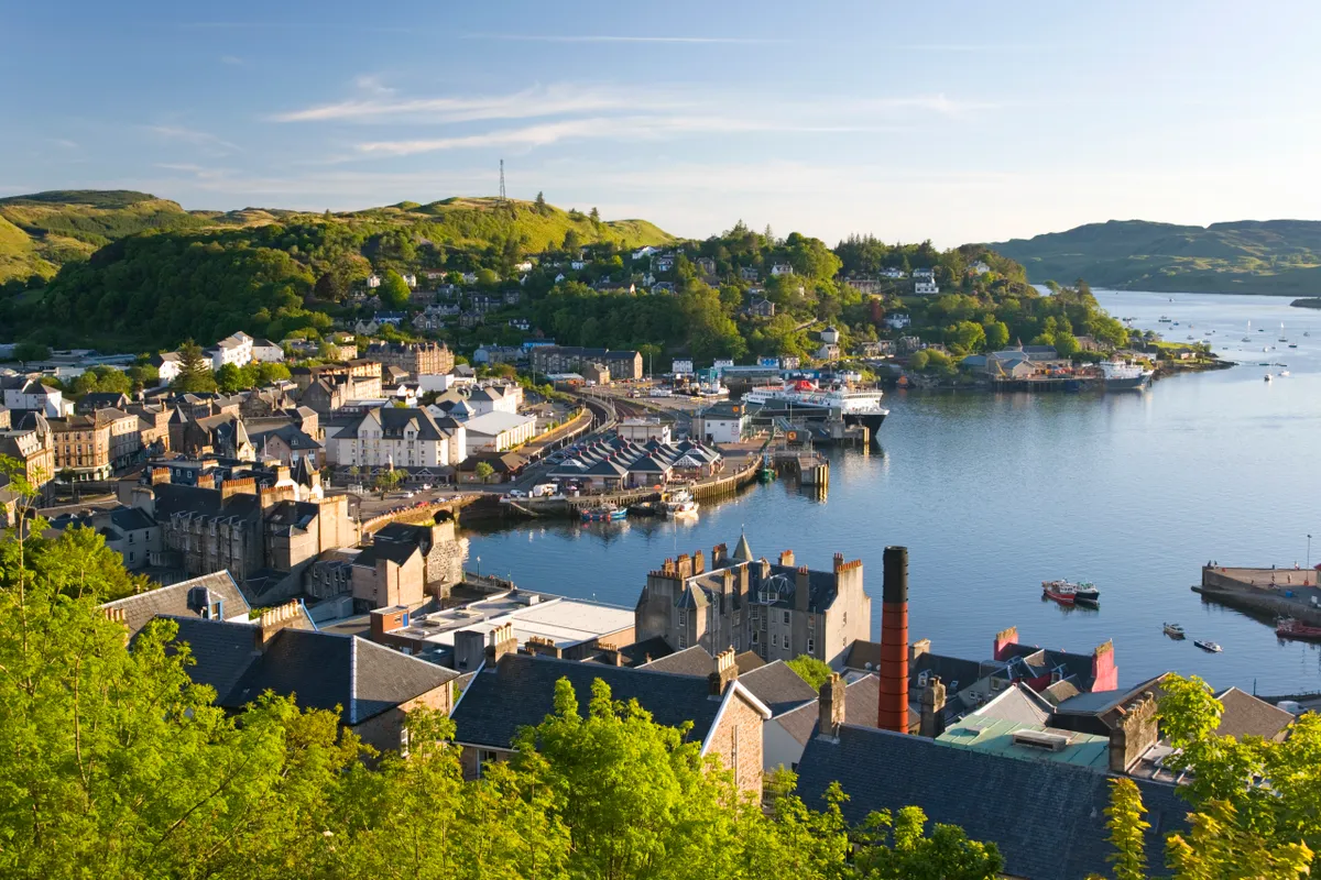 View over the harbour from McCaig's Tower, distillery chimney prominent, Oban, Argyll and Bute, Scotland, United Kingdom, Europe.