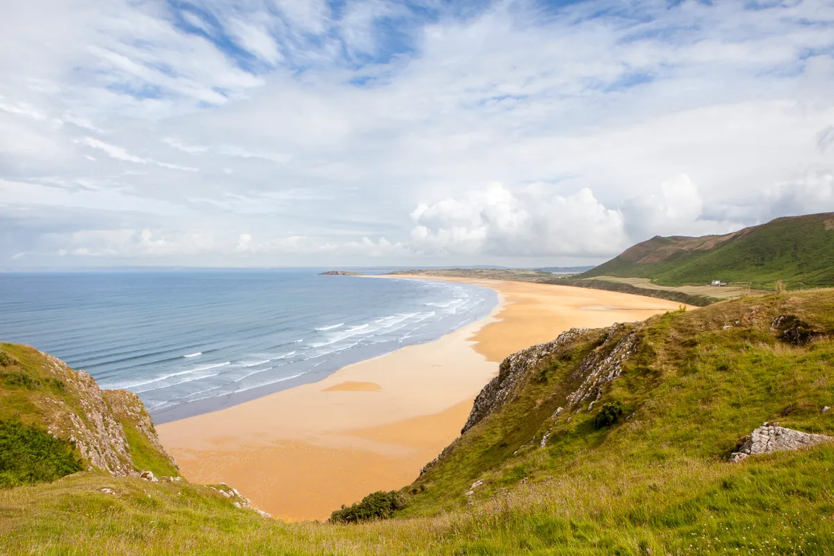 Rhossili Bay is the most westerly bay on the Gower peninsula in Wales, with a sandy beach three miles (5 km) long.