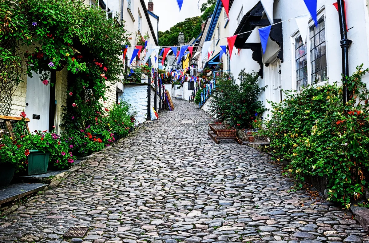 Cobbled street in Clovelly, North Devon, England. Picturesque English seaside town, early morning.