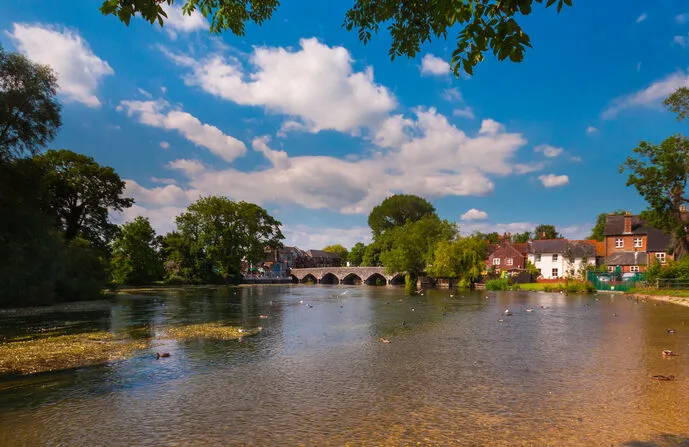 Hot, Sunny day on the River Avon looking towards the bridge arches of Fordingbridge