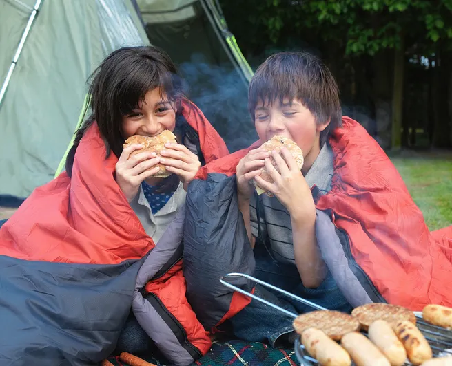 Young boy and girl camping