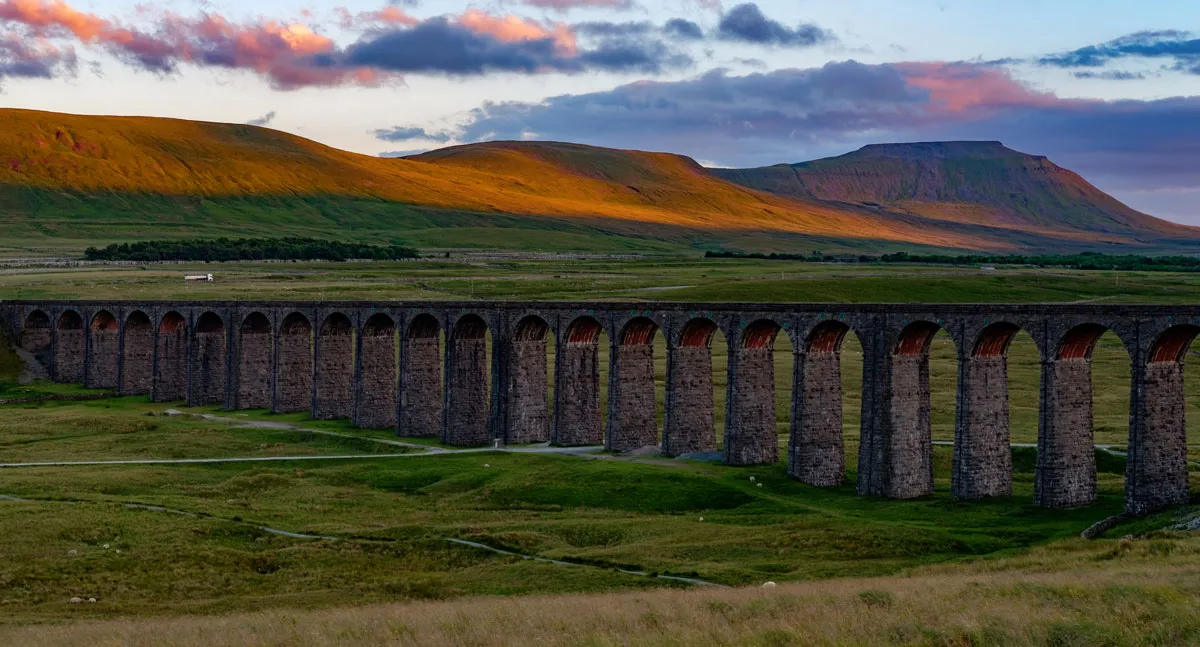Ingleborough in Yorkshire at sunset with wall in foreground