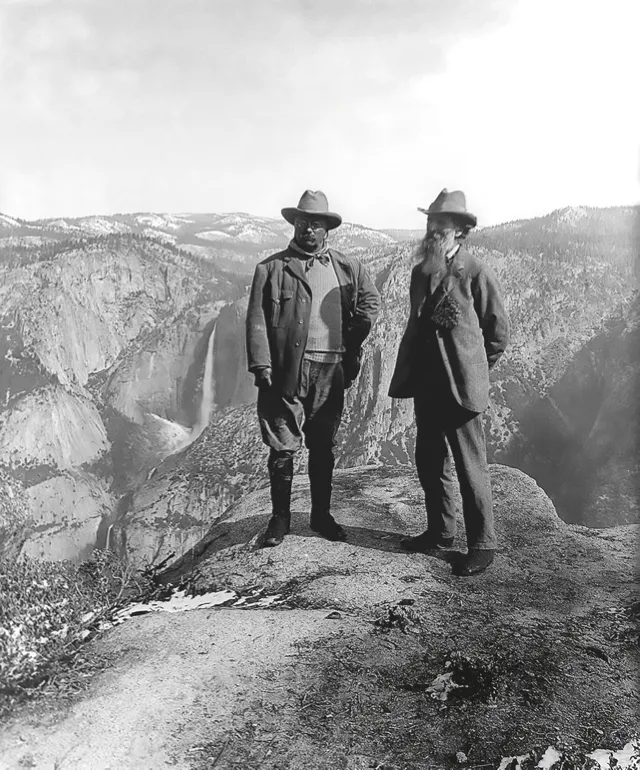 Two men at the top of a mountain
