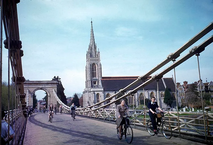 Cyclists cross Marlow Suspension Bridge (completed 1832, by architect Tierney Clark) over the Thames, Marlow, England, May 1944. The church in the background is the All Saints Parish (erected 1835). (Photo by Frank Scherschel/The LIFE Picture Collection/Getty Images)