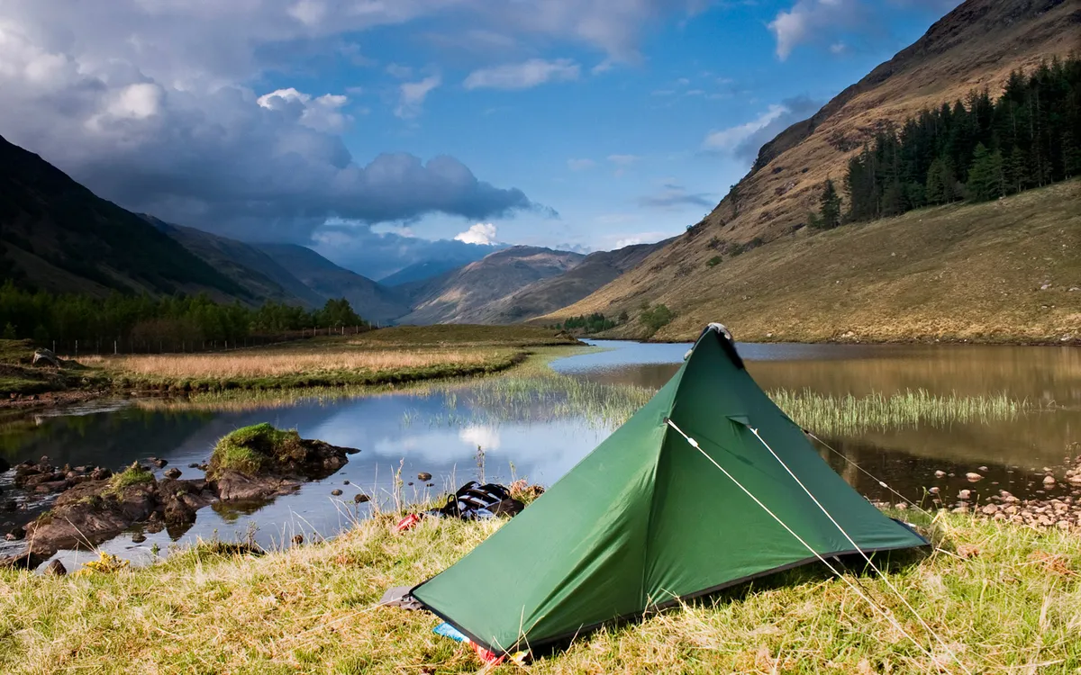Tent by a lake in the mountains