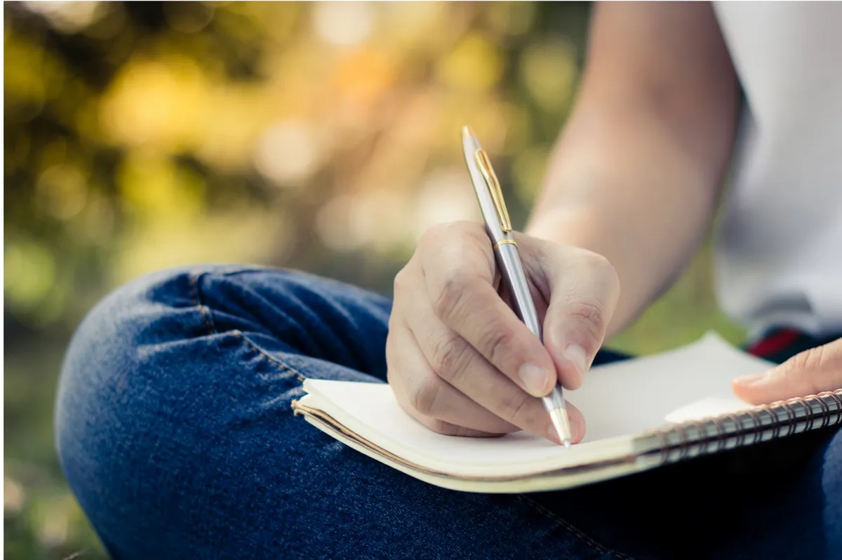 A women writing in her journal