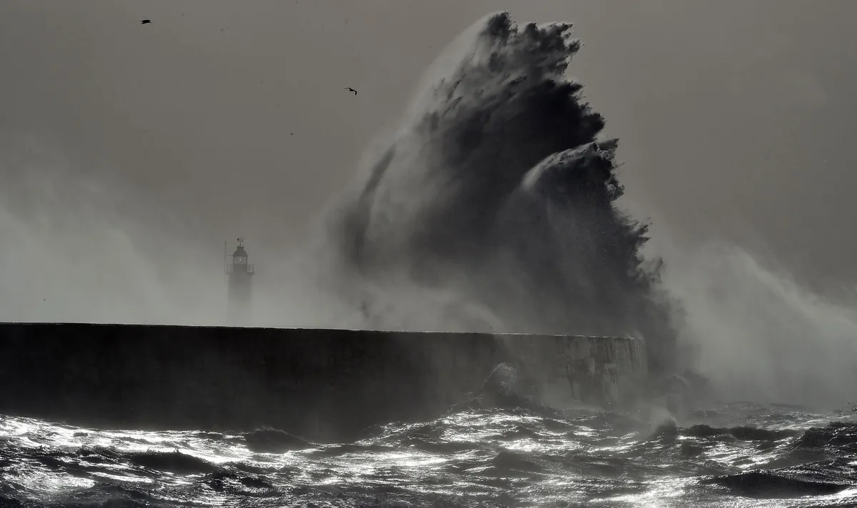 Wave hitting a sea wall/Getty