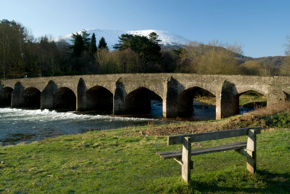 River with stone bridge and mountain view