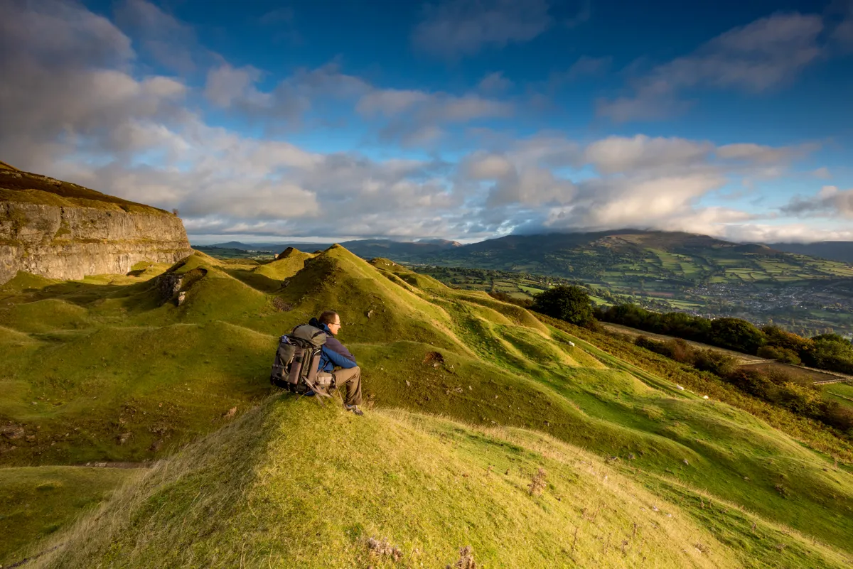 Hiker sitting enjoying the view on a hillside