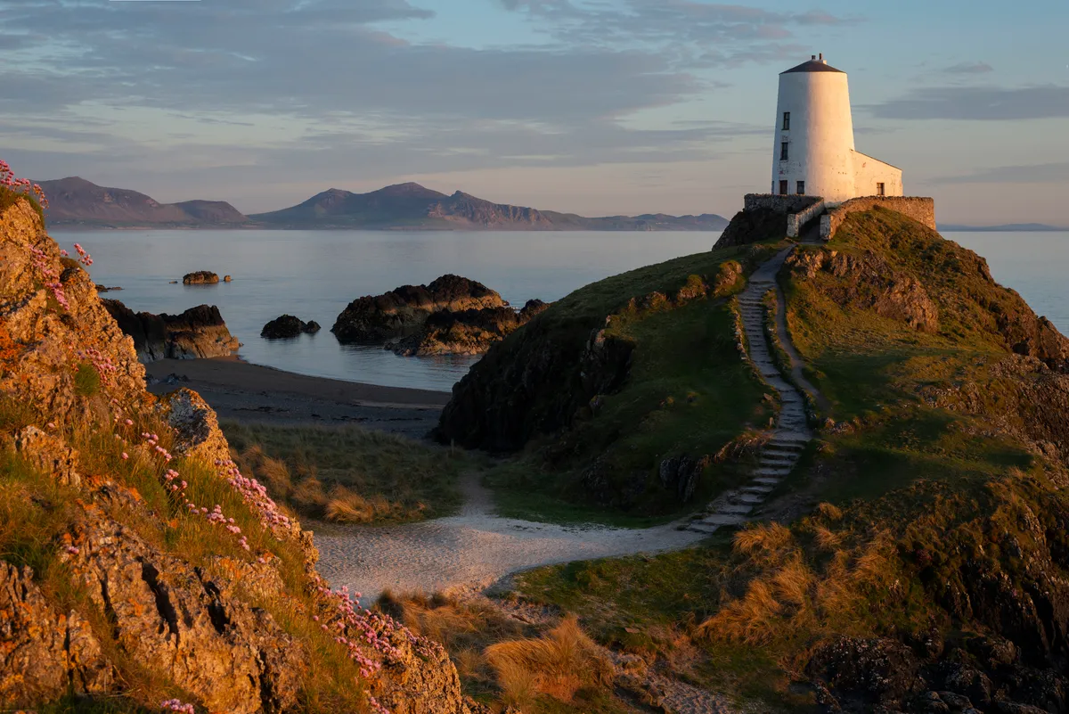 Llanddwyn Island Lighthouse in Snowdonia National Park at sunset, North Wales.