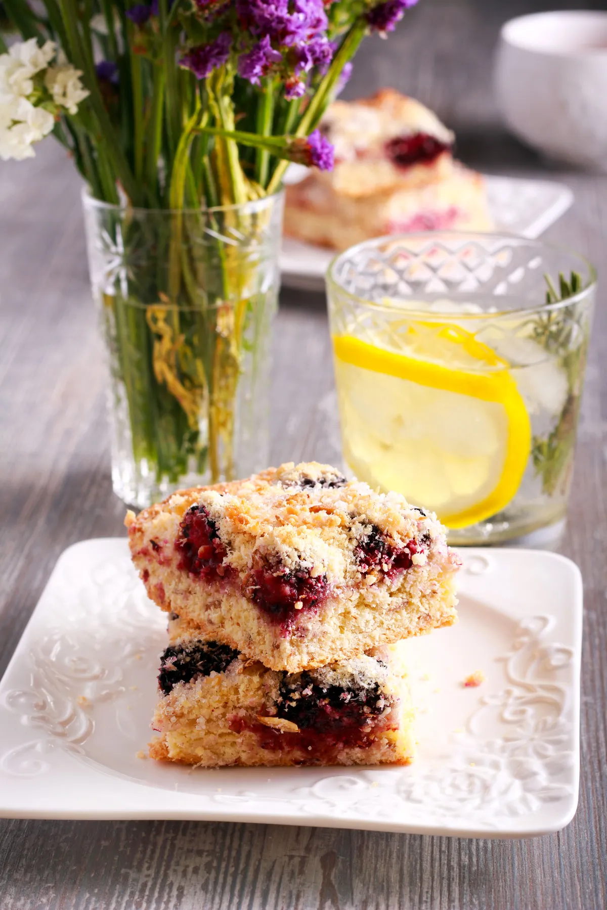 Apple and blackberry crumble squares with drink in glass