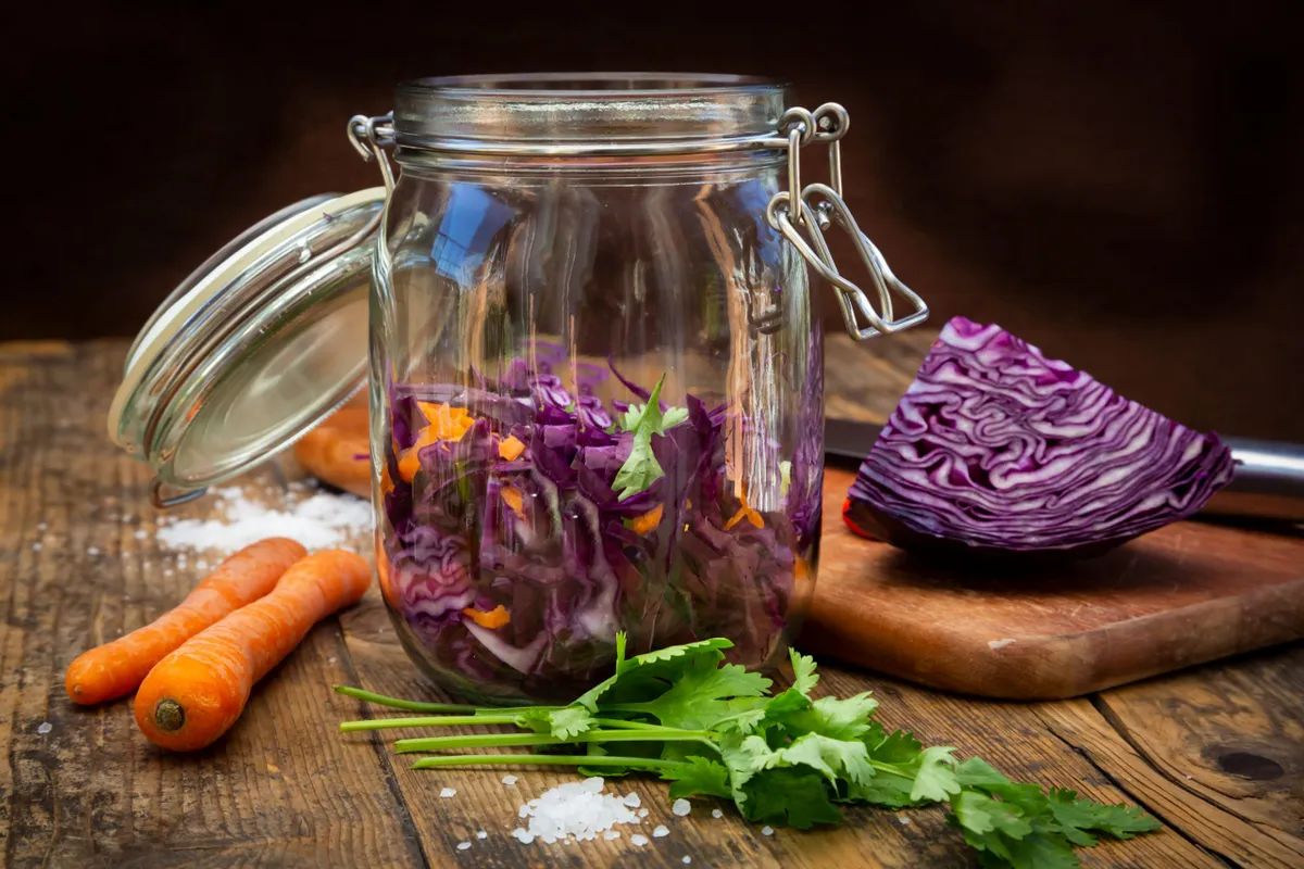 Vegetables in glass jar and wooden table