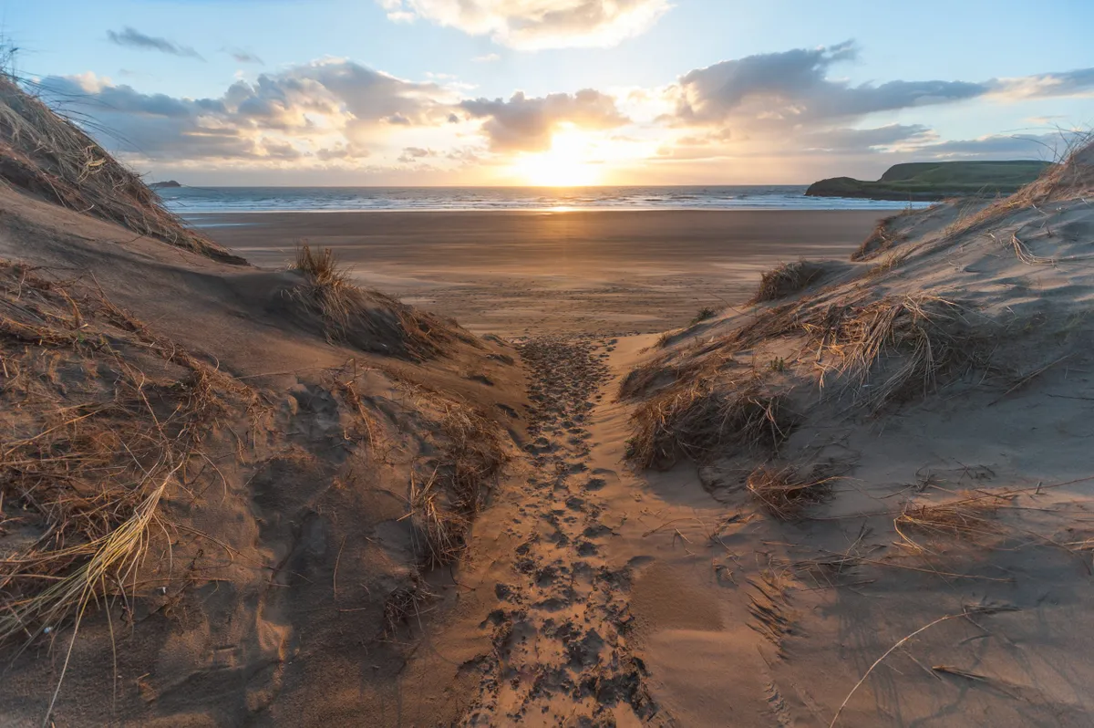 Sunset on the Gower with sea and sand