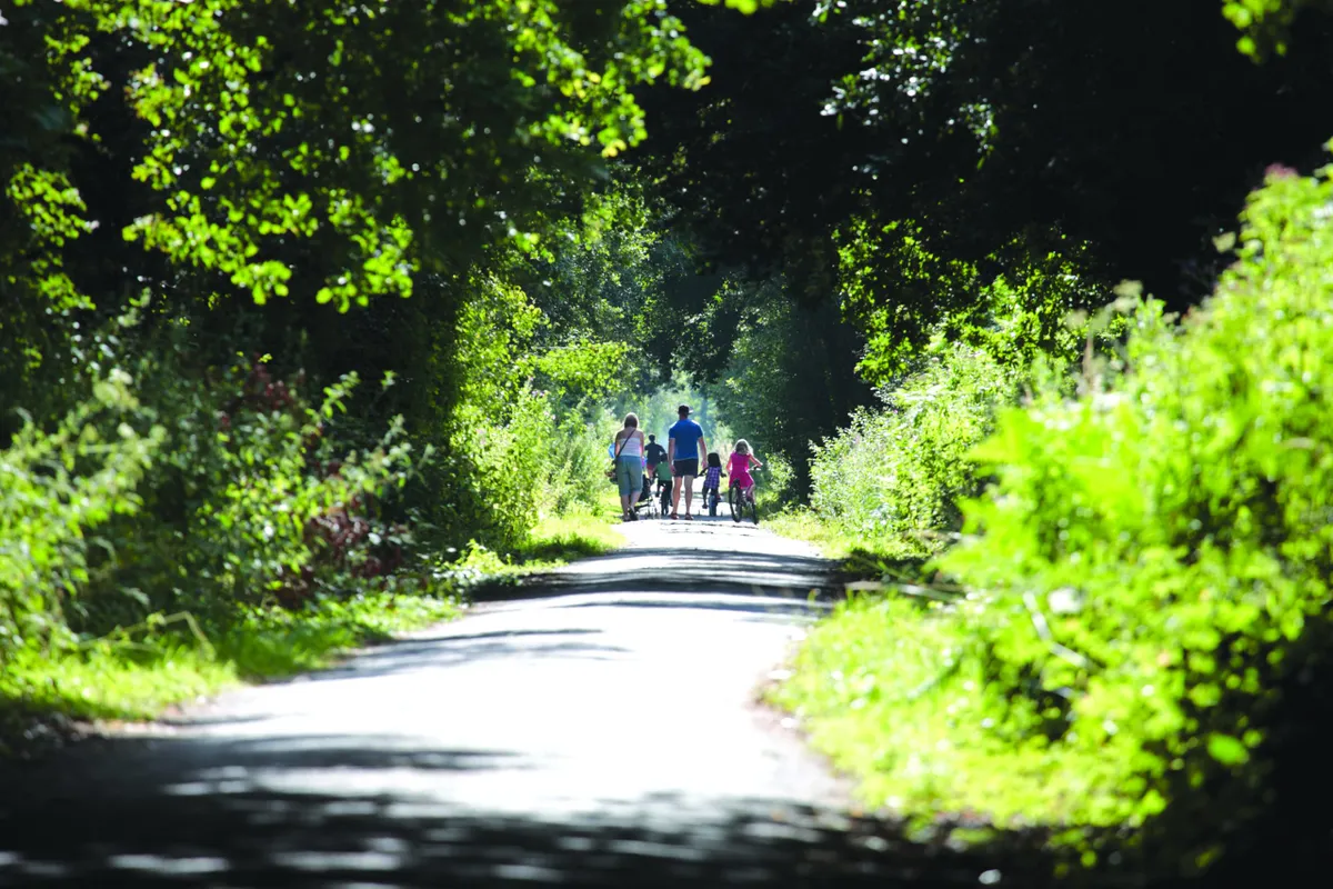 Family cycling North Devon's Tarka Trail near Fremington Quay