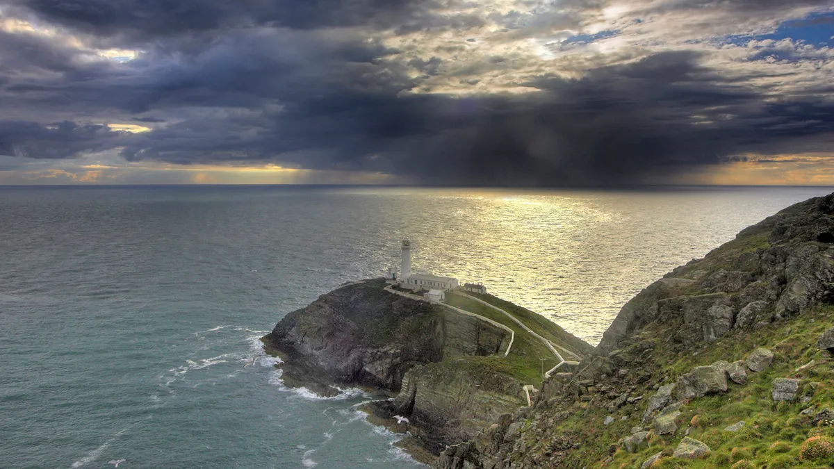View showing lighthouse with approaching storm, South Stack RSPB reserve, Wales ©RSPB Images