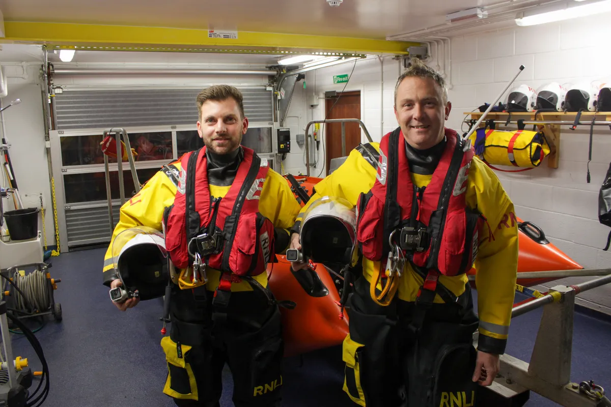 Two RNLI volunteers at the lifeboat station