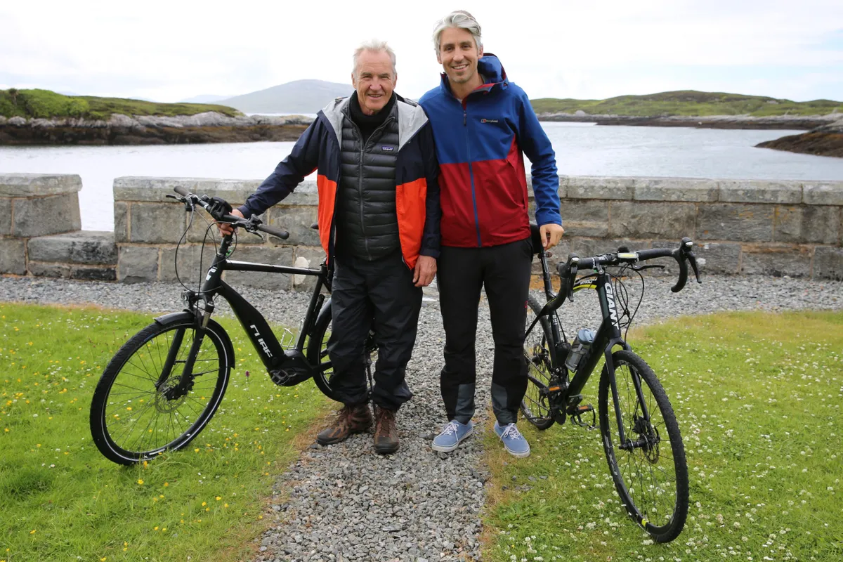 larry and george lamb with bicycles in front of lake