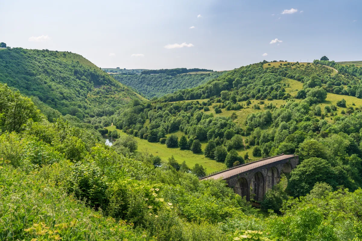 Viaduct through green hills
