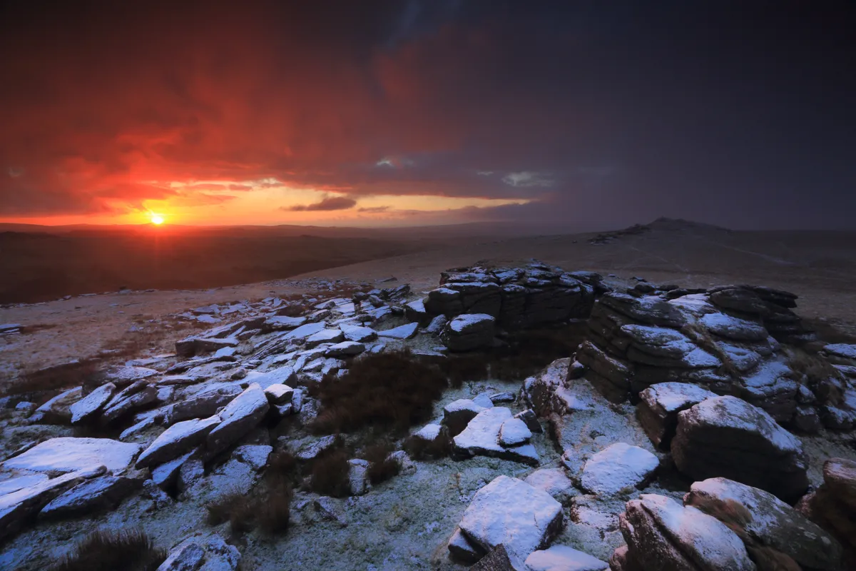 Snowing hill at sunrise
